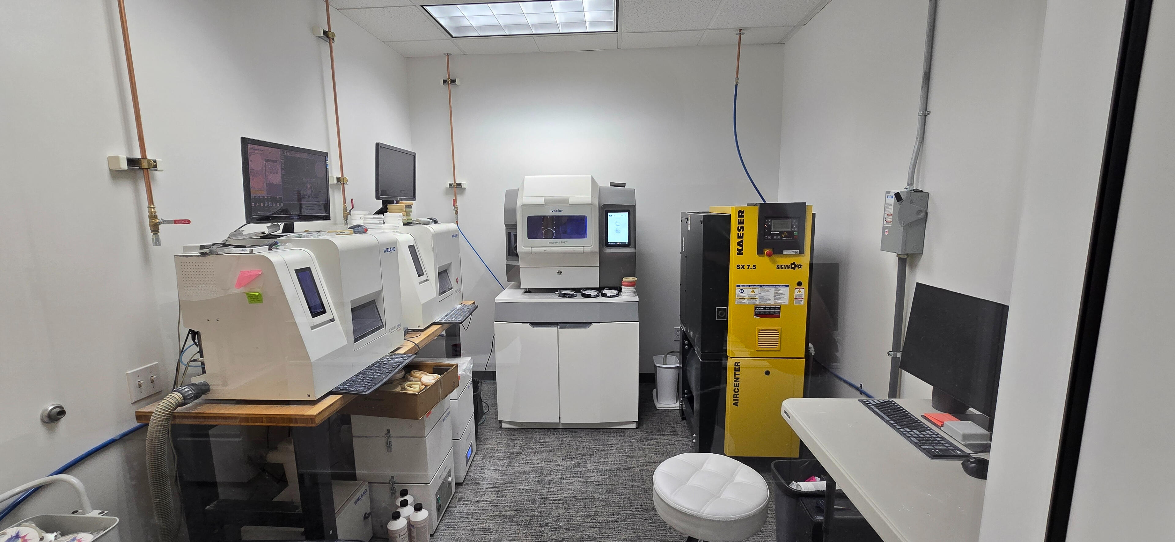 Clean modern dental lab interior at Rutherford Dental Lab in Livermore CA showing precision milling equipment and CAD CAM workflow for R.I.S.E. crown program